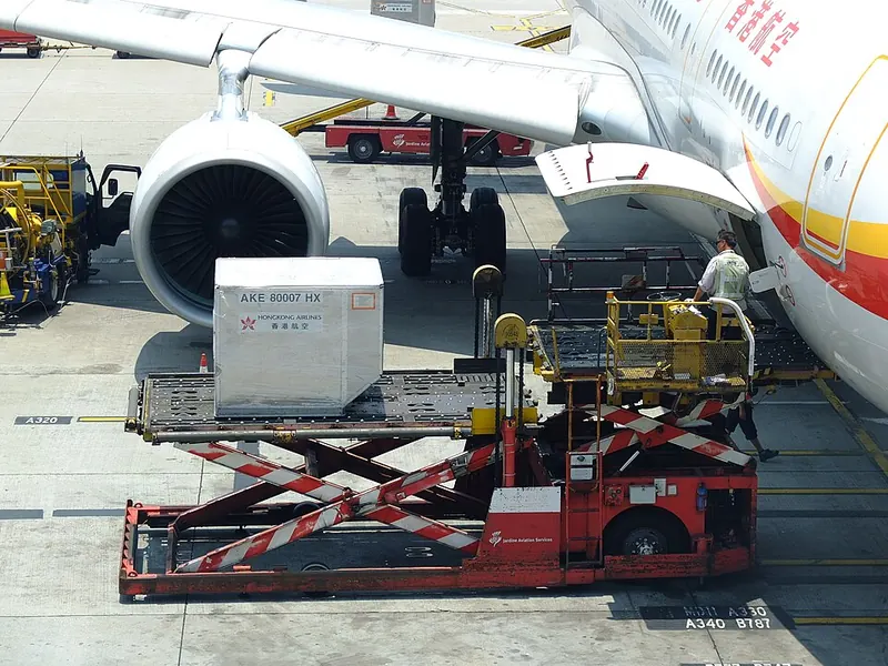 Ground crew operating a cargo loader